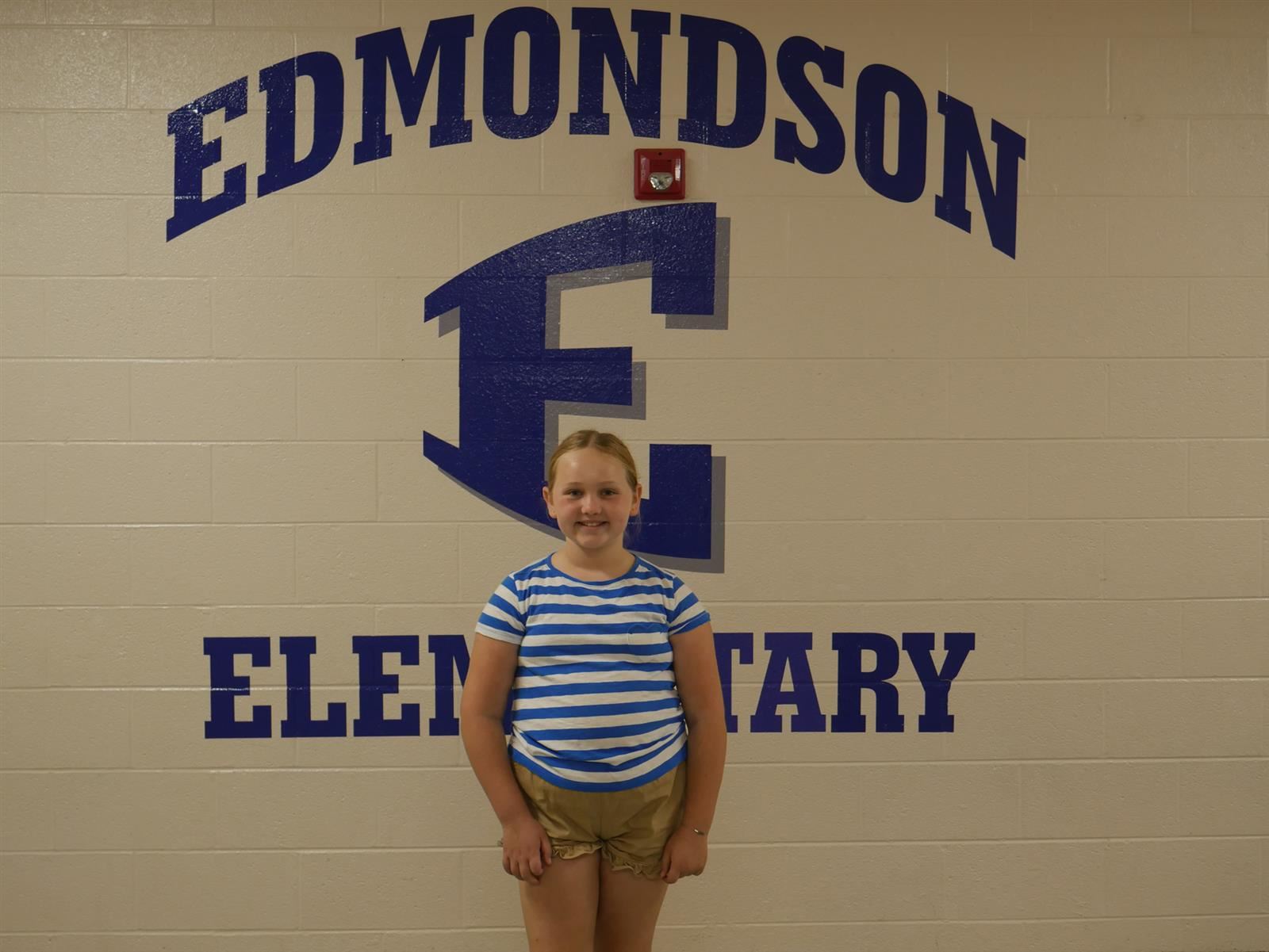 girl smiling in front of EES sign